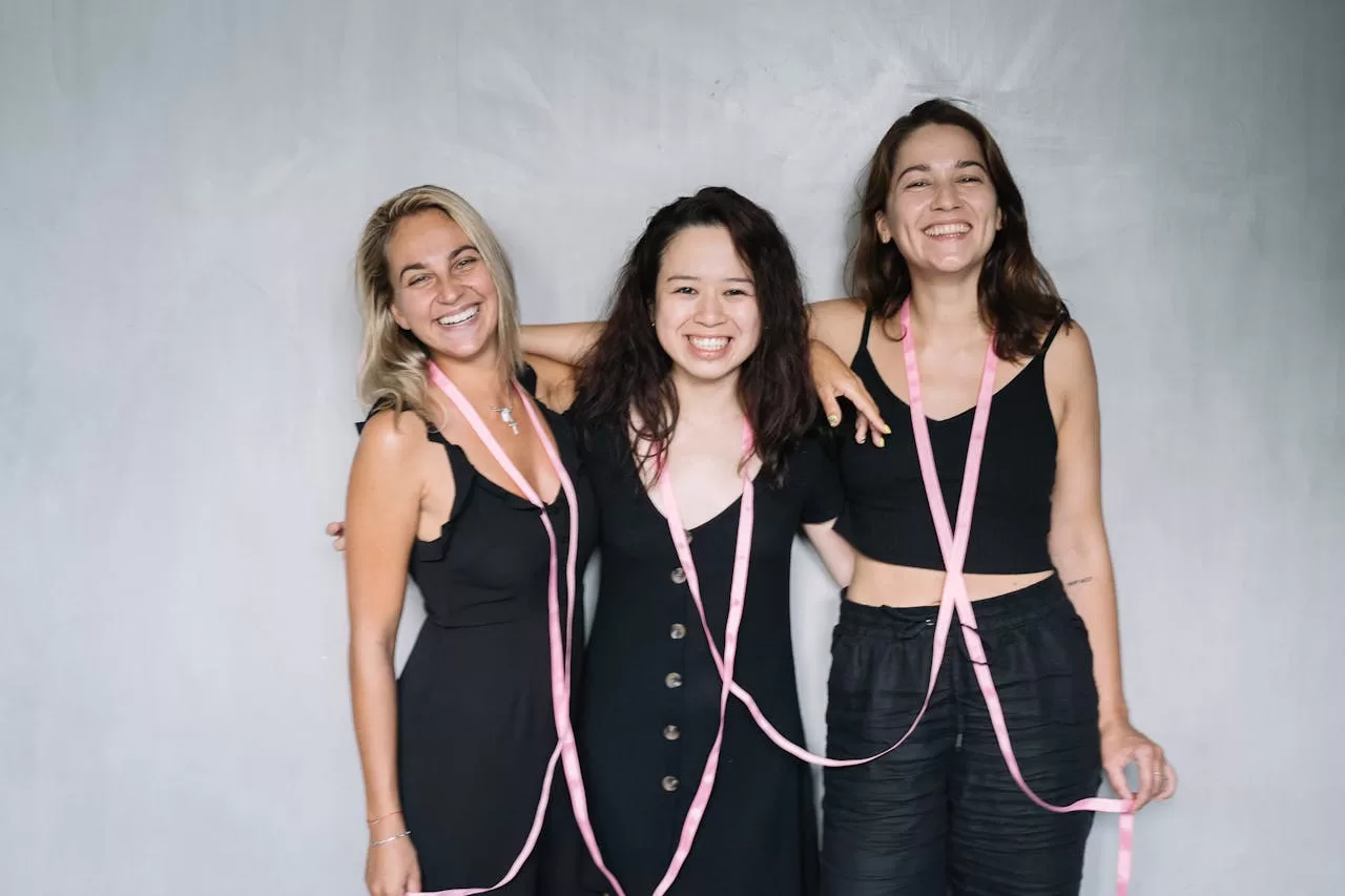 An image depicting three women of different age groups, symbolizing the various stages of life. Each woman is engaging with healthy foods, like fruits and vegetables, illustrating the concept of alkalizing the body for optimal health and wellness across all ages.