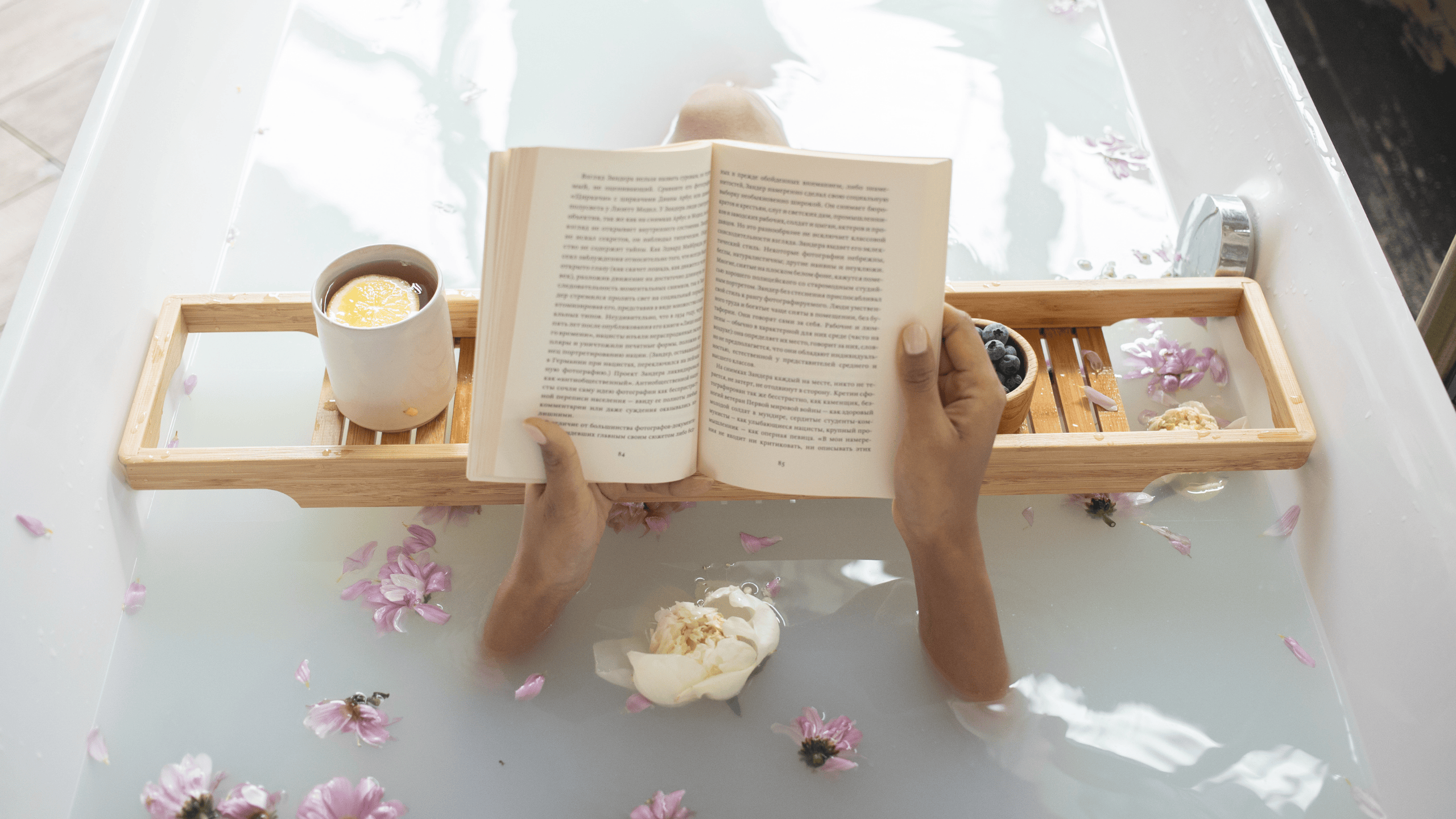 Woman relaxing while reading in bathtub, representing holistic stress management and self-care practices that support healthy metabolism and overall wellness