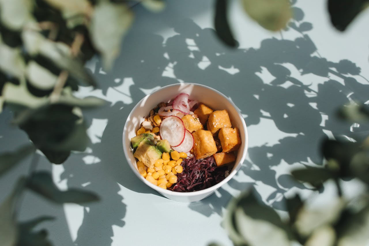 A bowl of vibrant, healthy food featuring a colorful array of fresh vegetables, grains, and proteins, symbolizing the power of food as medicine and the importance of conscious eating choices.